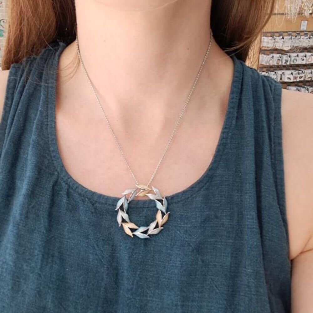 Silver Tone Necklace with Blue, Grey and Yellow Leafy Circle Pendant